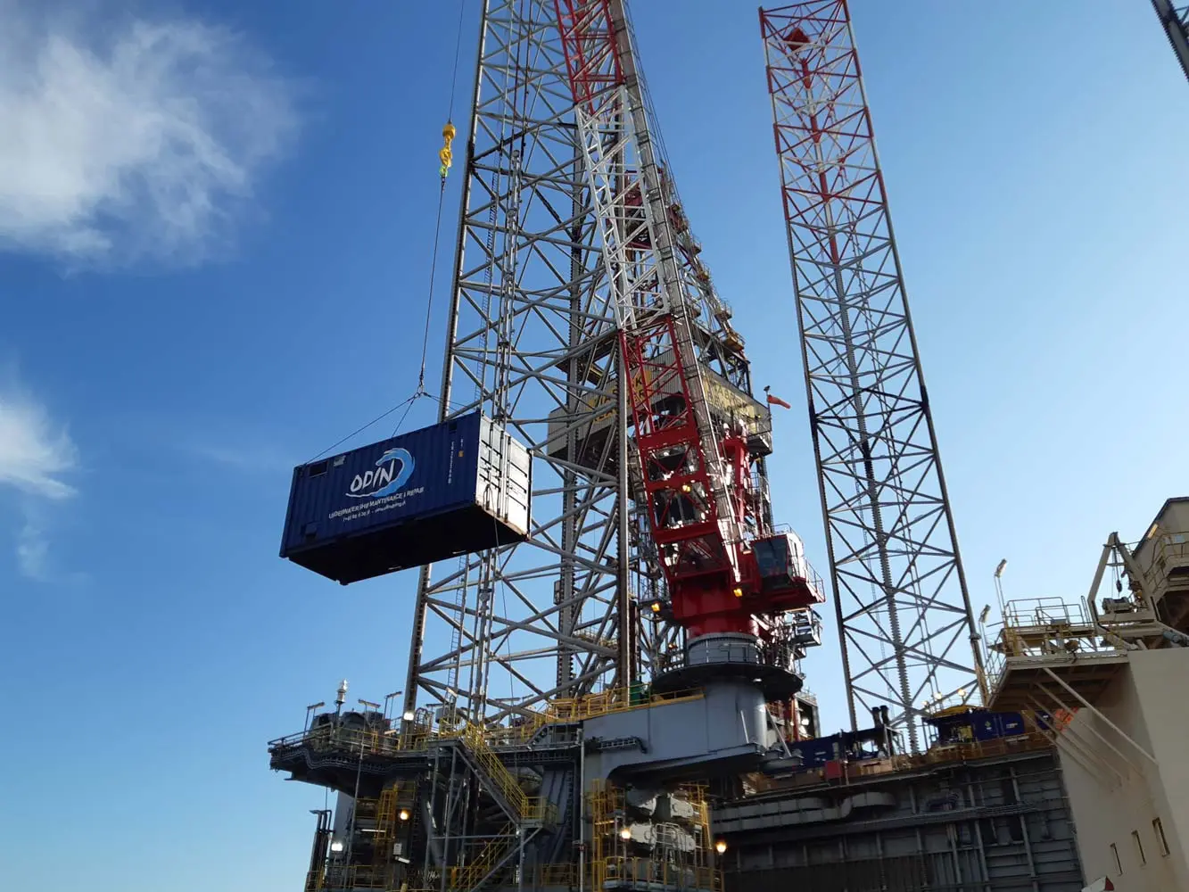 Container getting lifted by a crane